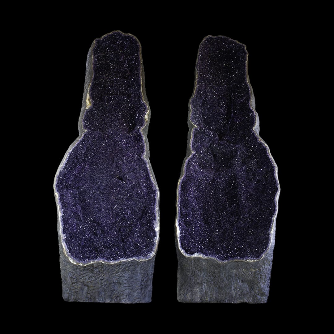 Two giant open amethyst geodes, standing upright