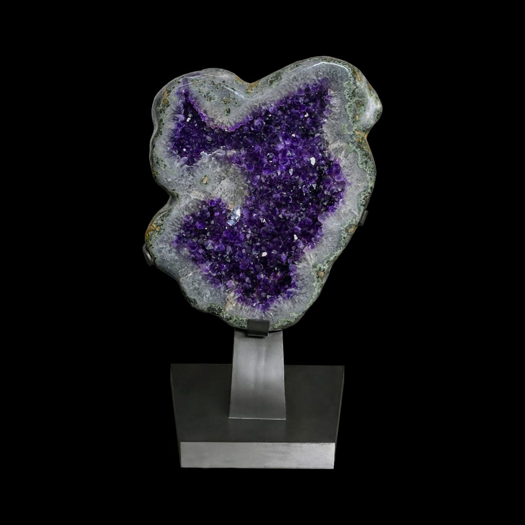 A lobed amethyst geode on a metal stand