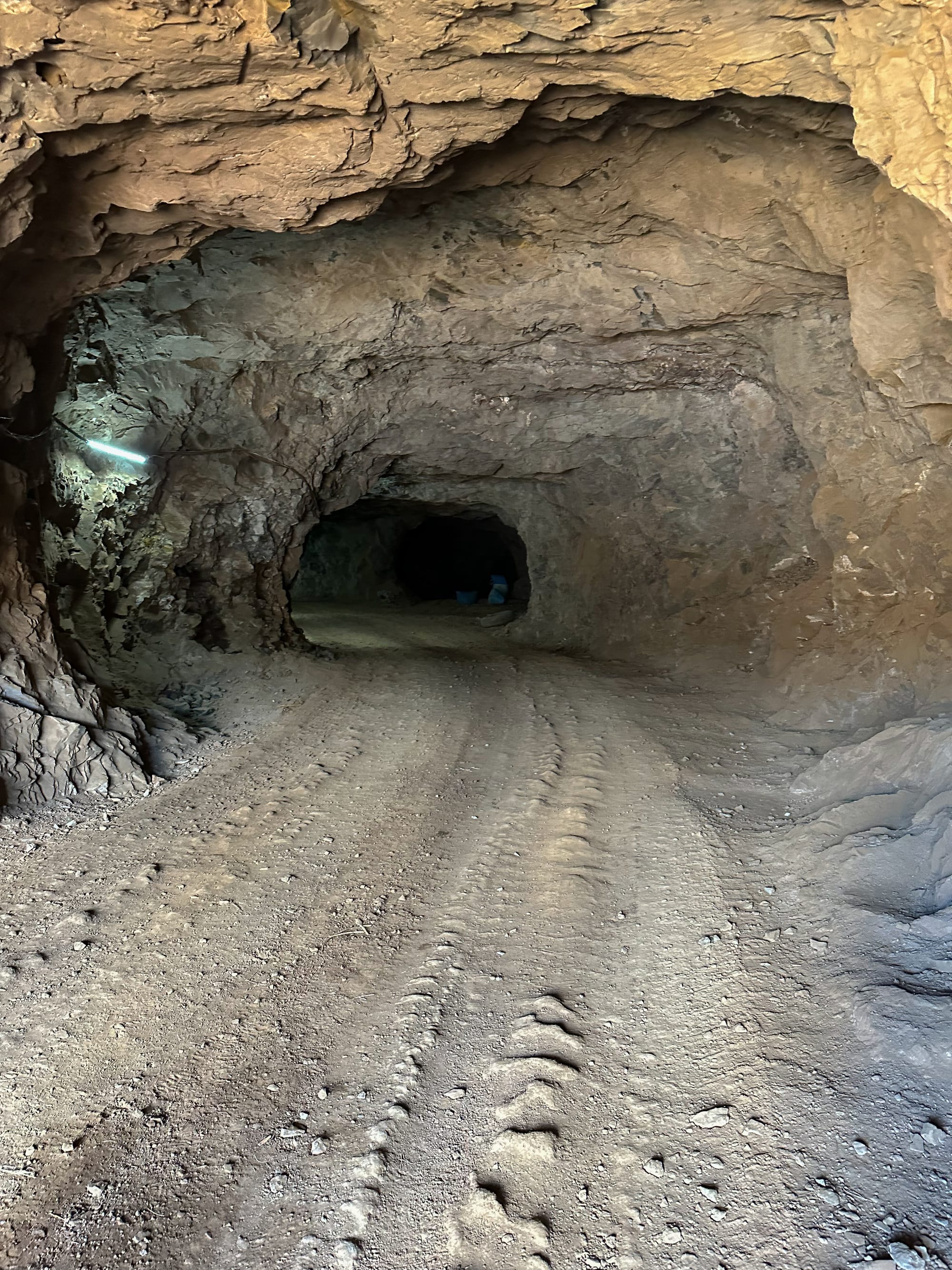 Inside a mine gallery, with machinery tracks on the floor